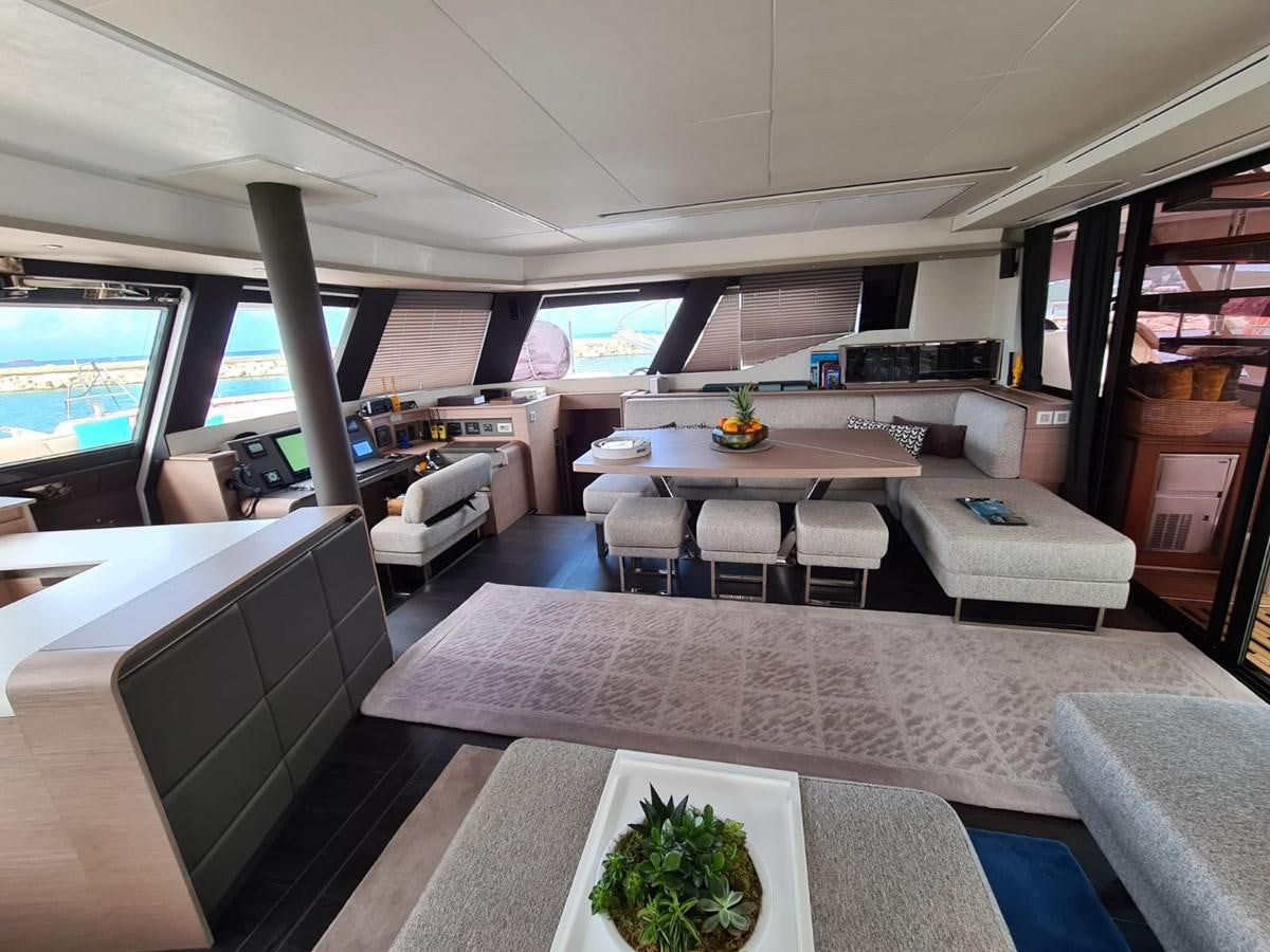 a room with a table and chairs aboard LISA OF THE SEAS Yacht for Sale