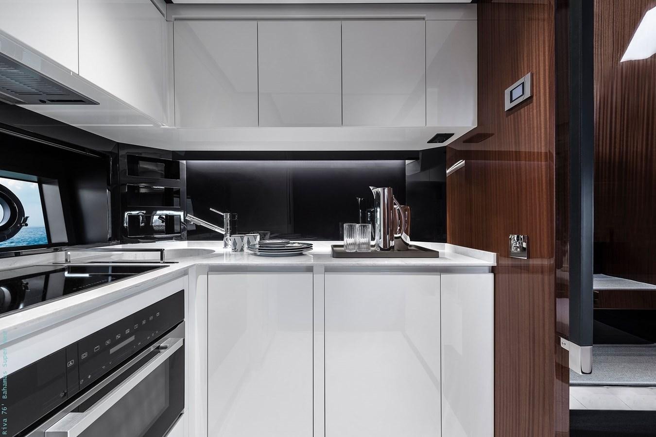 a kitchen with white cabinets aboard RIVA 76 BAHAMAS SUPER  Yacht for Sale