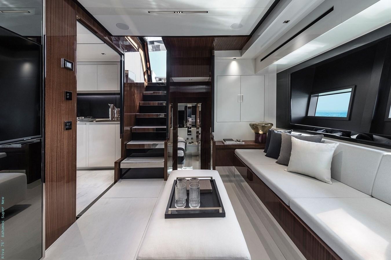 a room with a couch and a tv aboard RIVA 76 BAHAMAS SUPER  Yacht for Sale