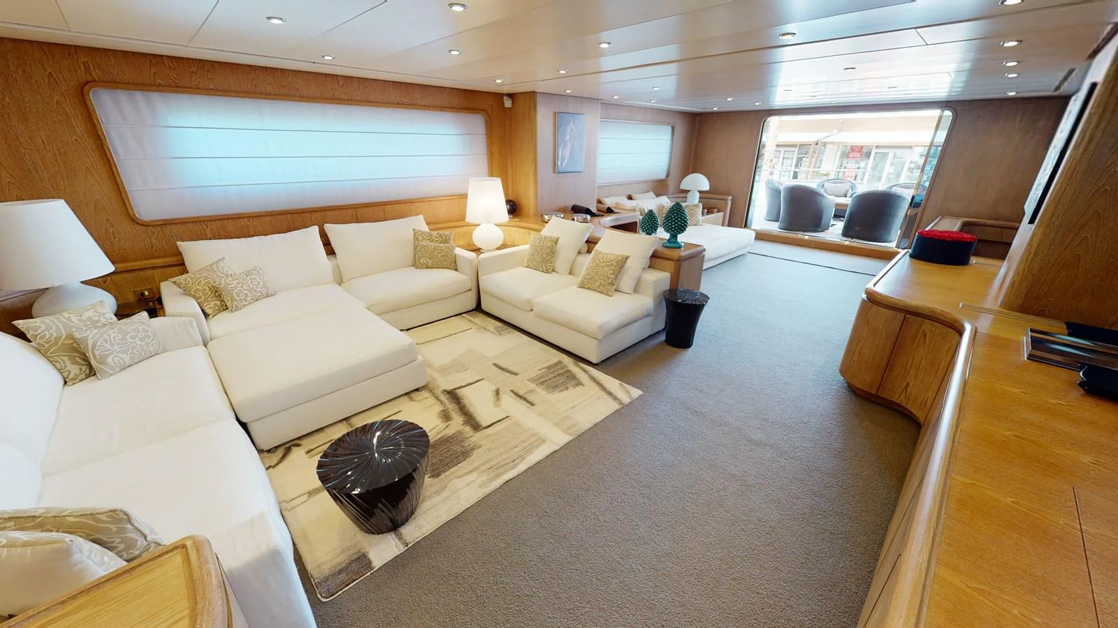 a living room with a couch and a table aboard IXIA Yacht for Sale
