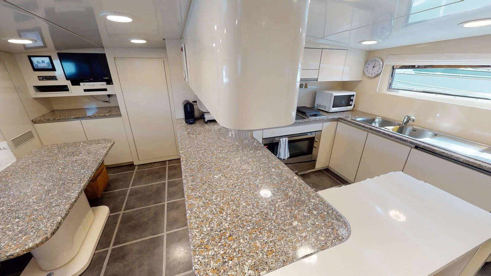 a kitchen with a marble counter top aboard IXIA Yacht for Sale