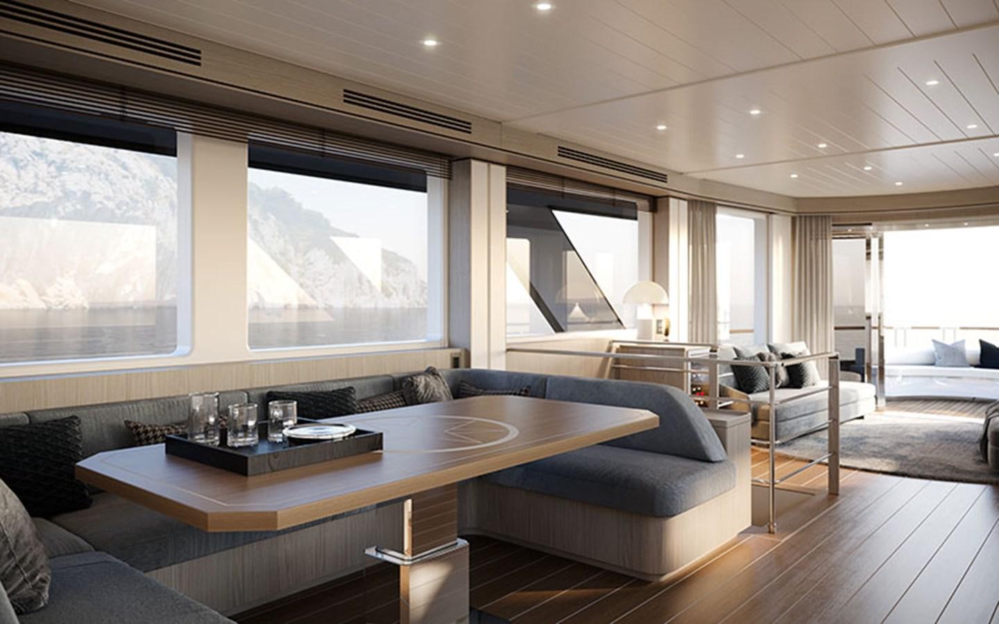 a large living room with a large table and a large window aboard AF Yacht for Sale