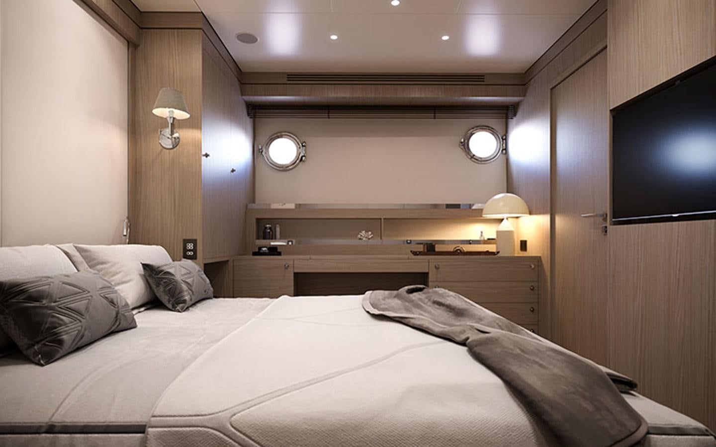 a bed with a television on the wall aboard AF Yacht for Sale