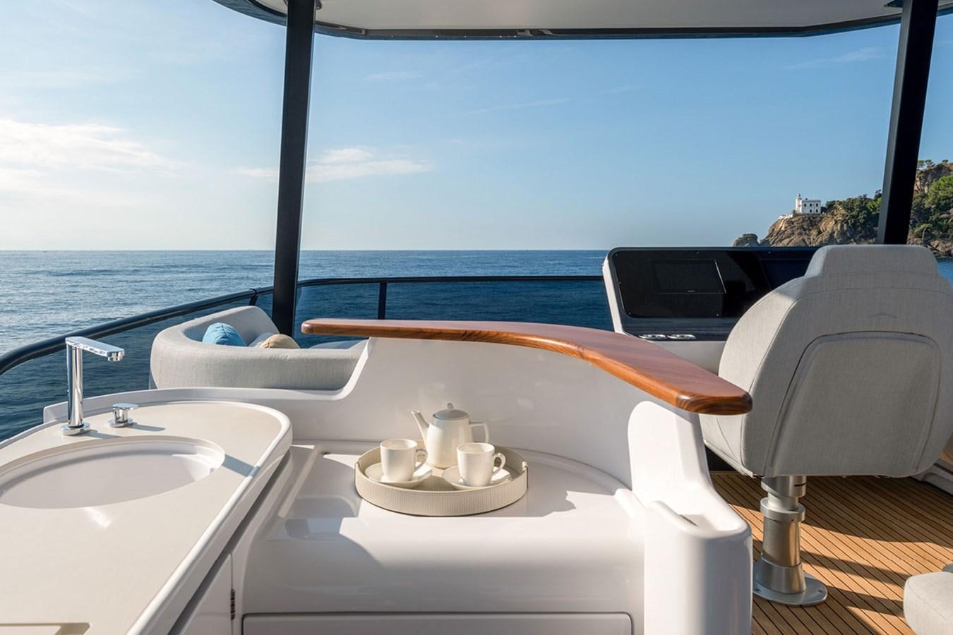a boat with a sink and a chair on a deck aboard SUNSTROKE Yacht for Sale