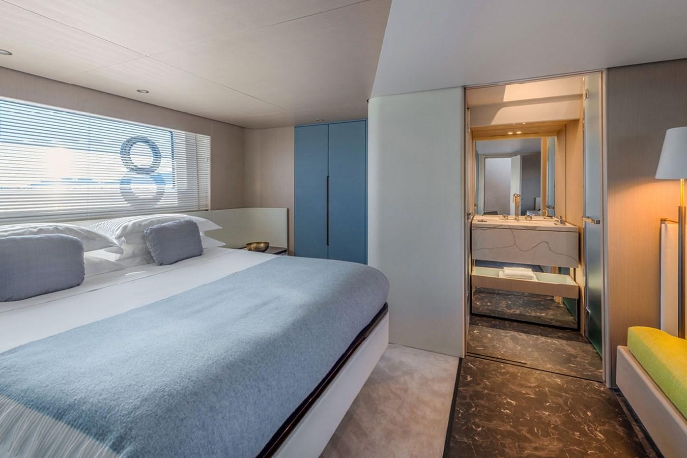 a bedroom with a bed and a desk aboard SUNSTROKE Yacht for Sale