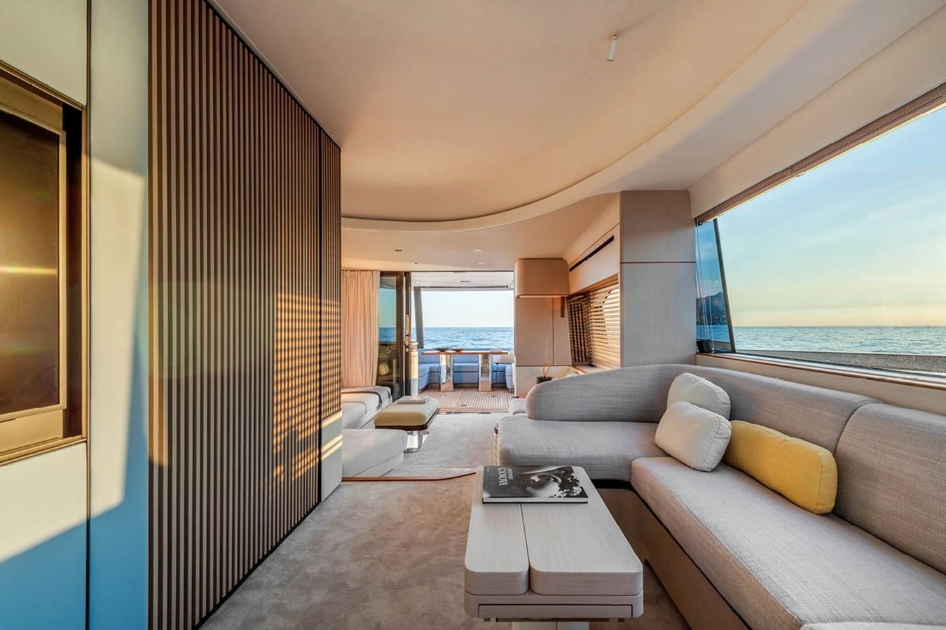 a room with a couch and a table and a large window aboard SUNSTROKE Yacht for Sale