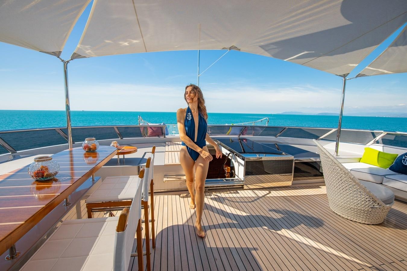 a person standing on a deck of a boat aboard HATT MILL Yacht for Charter