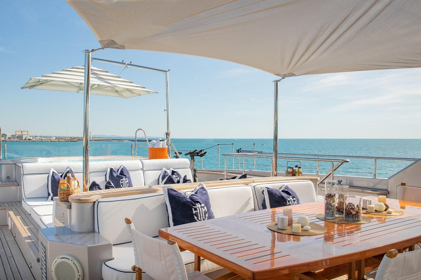 a table with chairs and umbrellas on it aboard HATT MILL Yacht for Charter