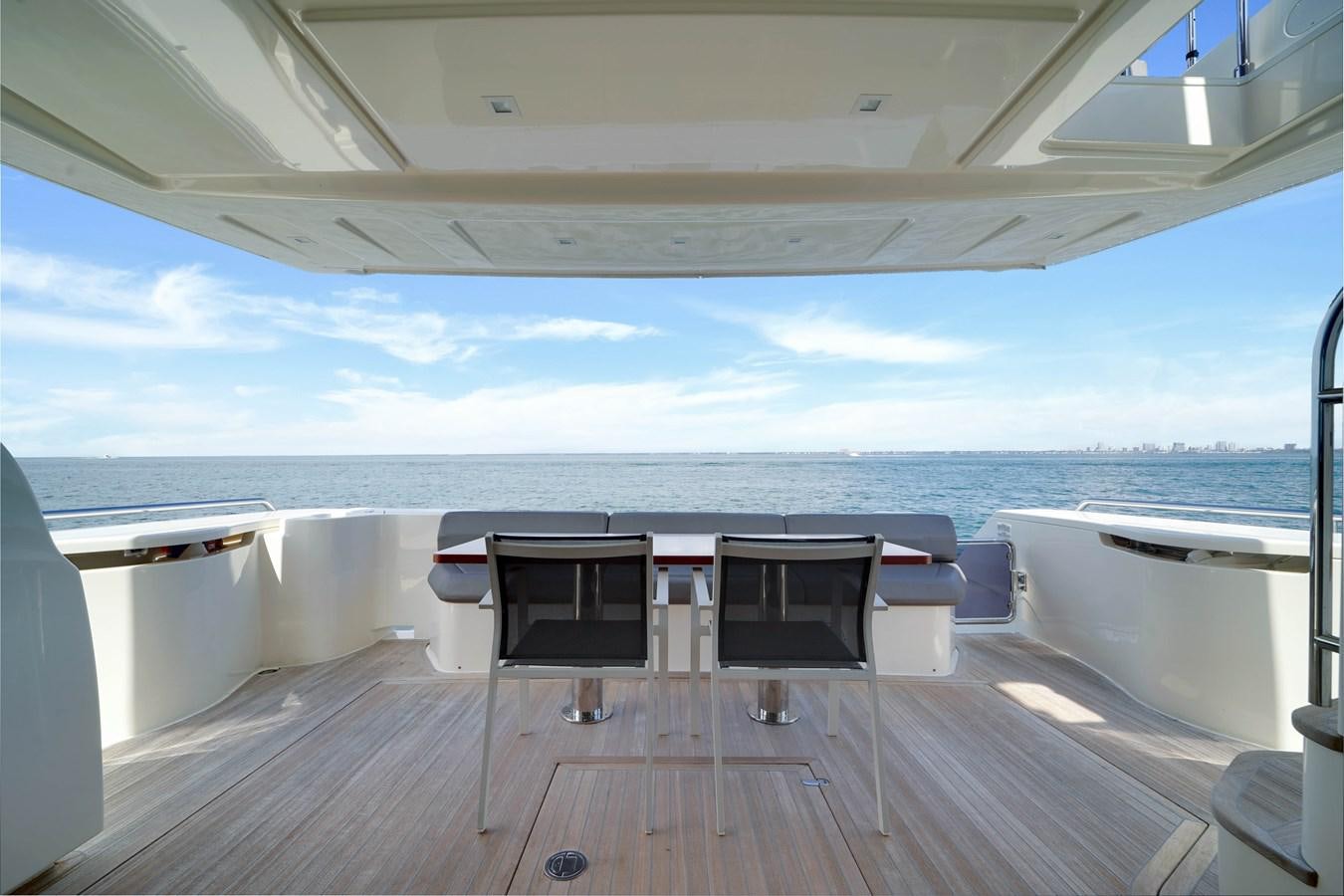 a deck with chairs and a table on it aboard G3 Yacht for Sale