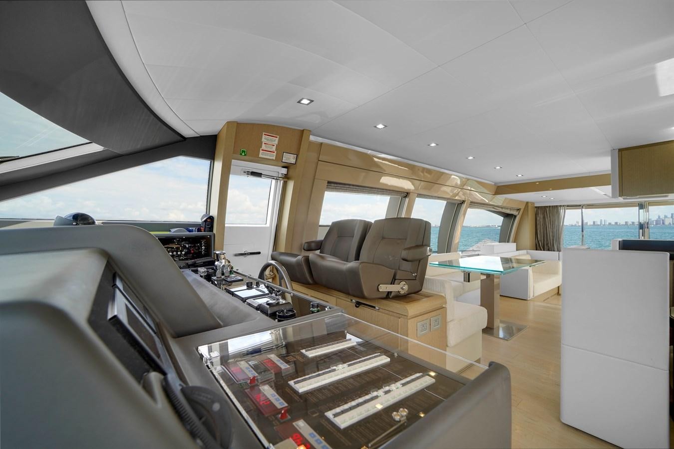 inside of a vehicle with a desk and chairs and a window aboard G3 Yacht for Sale