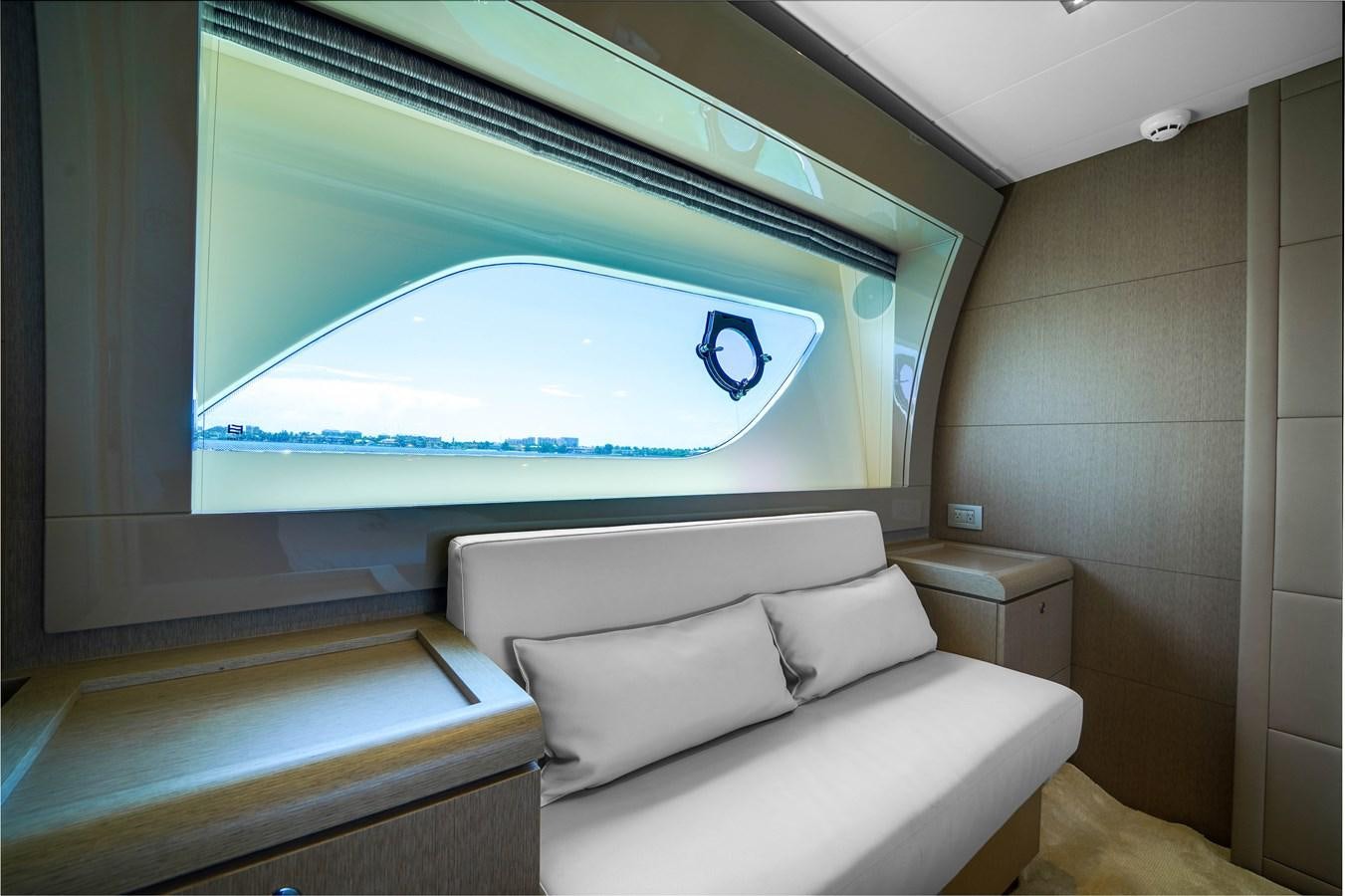 a room with a couch and a large window aboard G3 Yacht for Sale