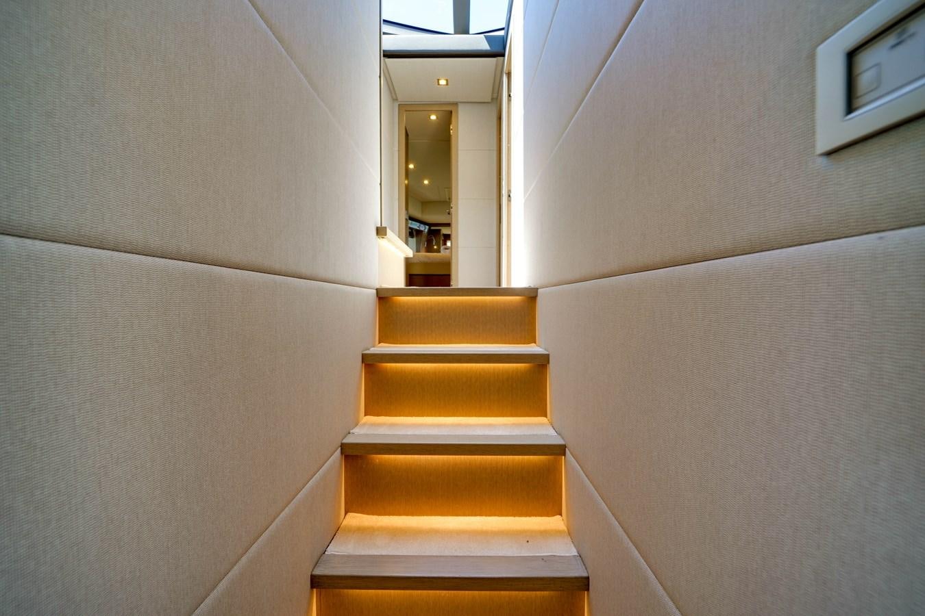 a staircase with a mirror above it aboard G3 Yacht for Sale