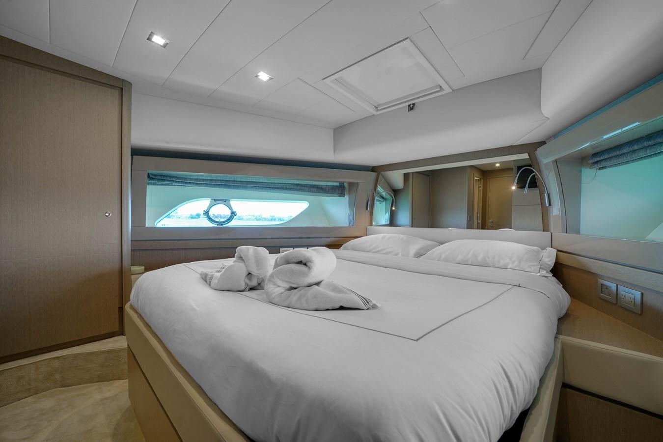 a room with a bed and a television on the wall aboard G3 Yacht for Sale