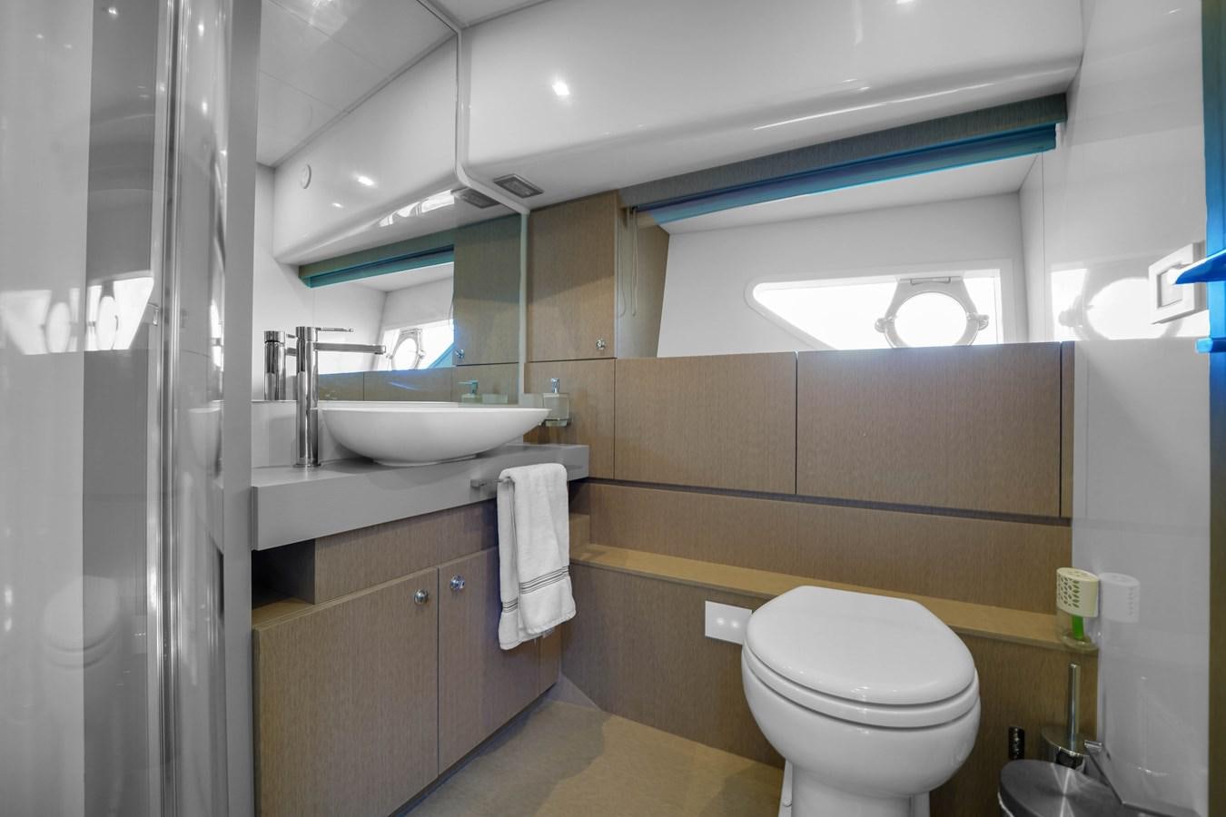 a bathroom with a sink toilet and a mirror aboard G3 Yacht for Sale