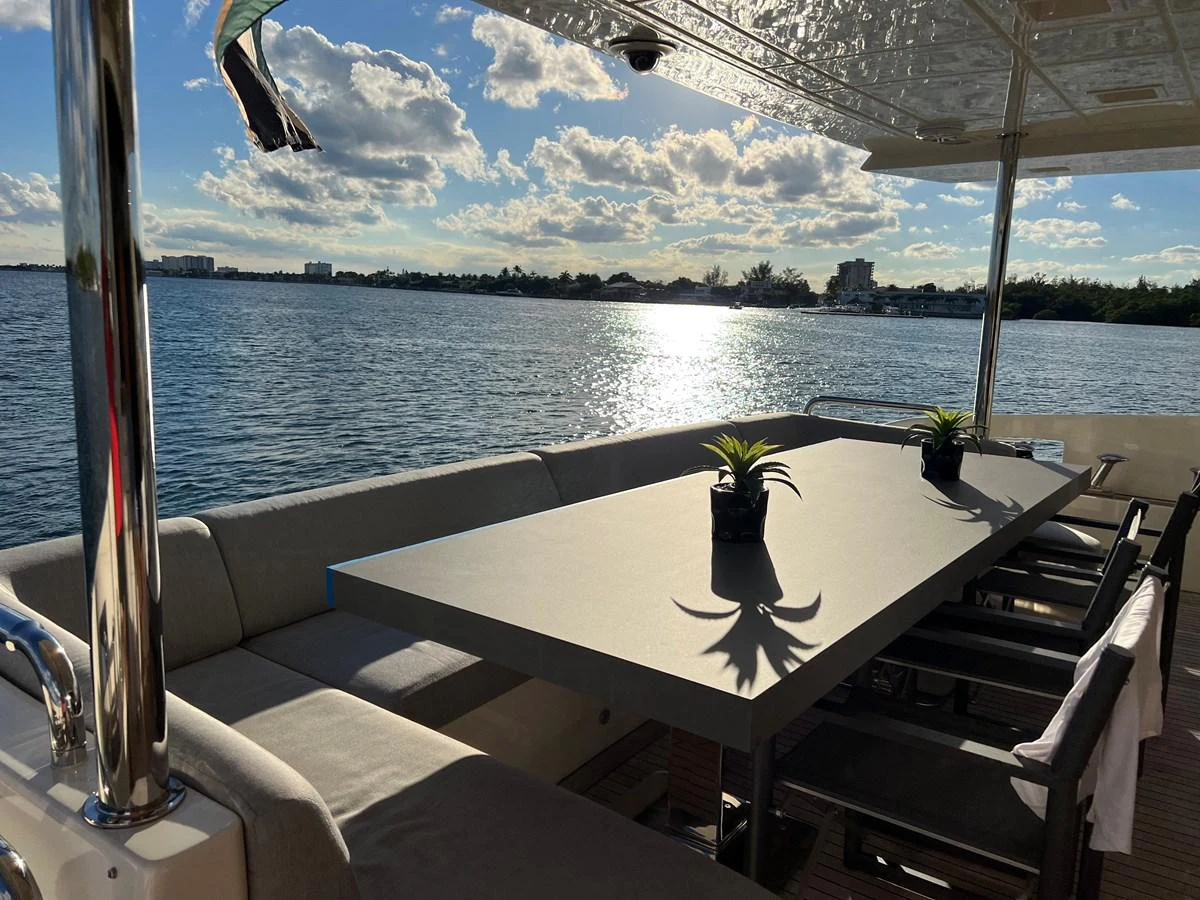 a table with a plant on it by a body of water aboard BT-2 Yacht for Sale