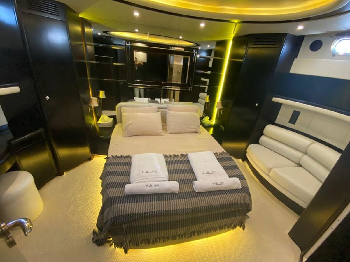 a room with a bed and a table aboard NILE Yacht for Sale