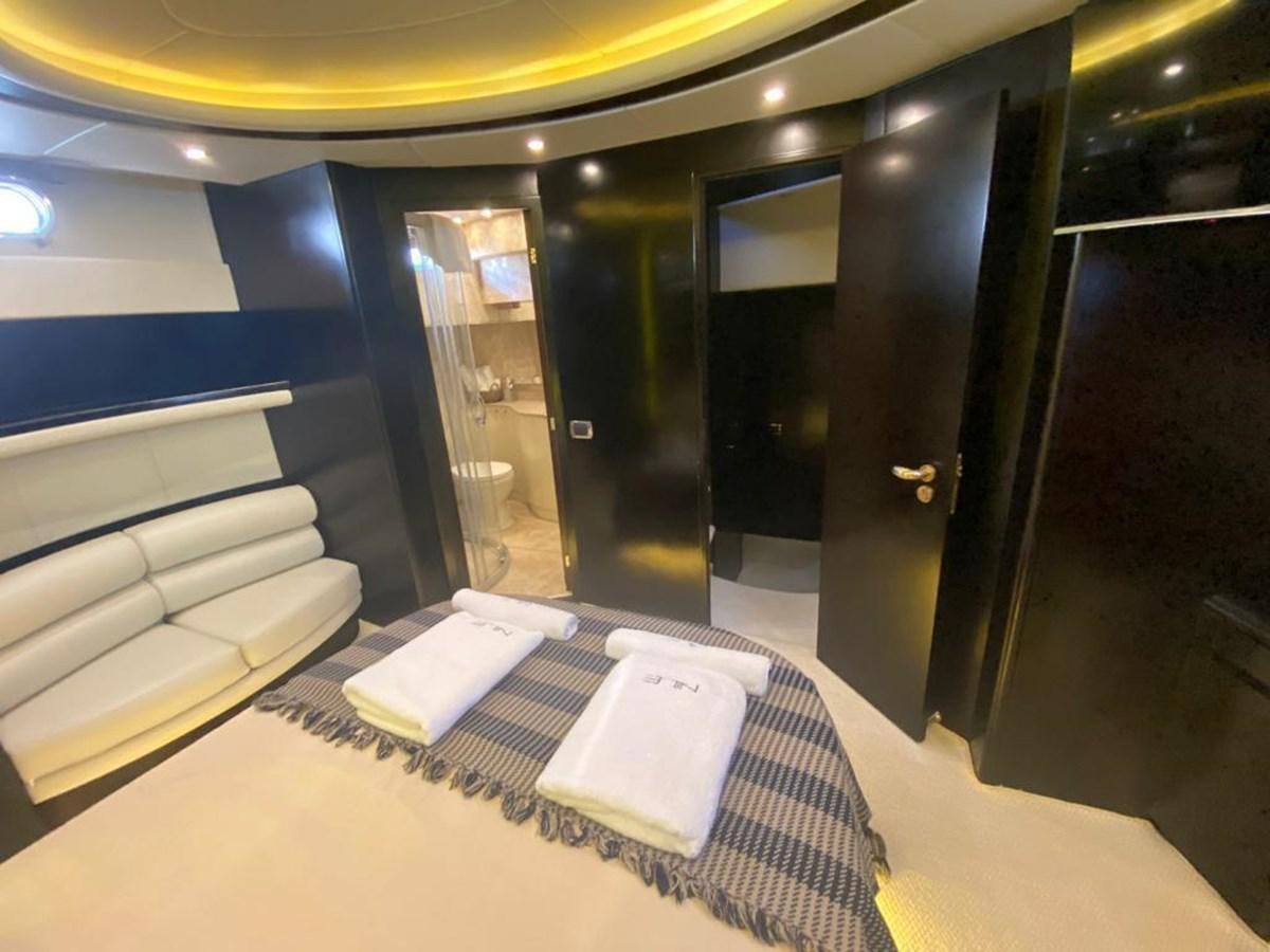 a room with a bed and a book on the floor aboard NILE Yacht for Sale