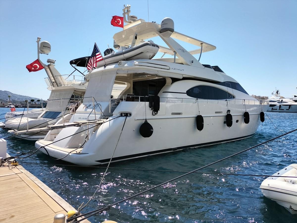 a white boat with a flag on it aboard NILE Yacht for Sale