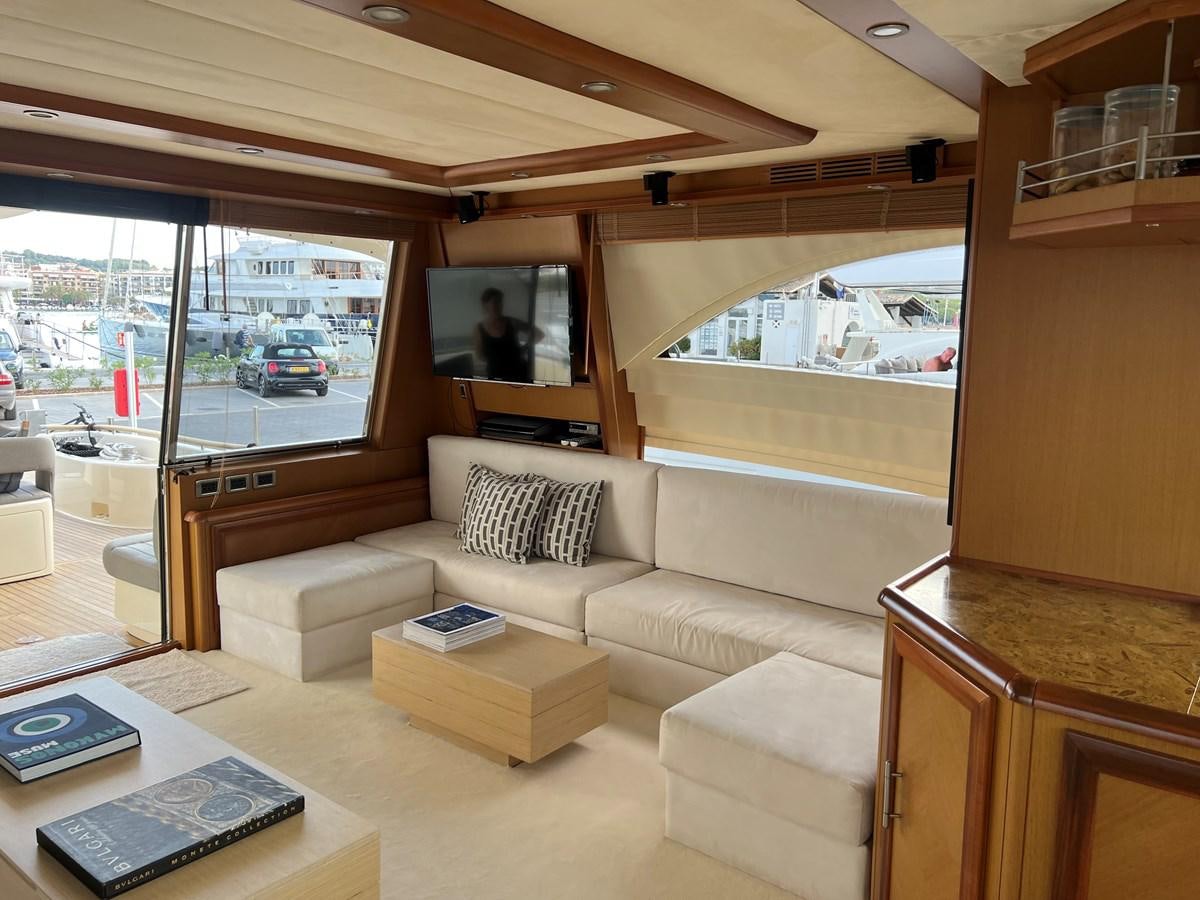 a living room with a large window aboard B Yacht for Sale