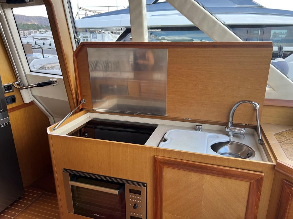 a kitchen with a sink and a microwave aboard B Yacht for Sale