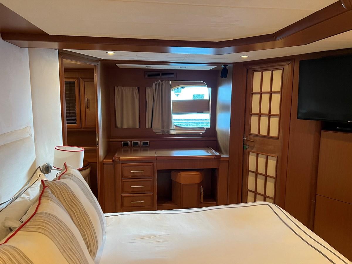 a room with a bed and a television aboard B Yacht for Sale
