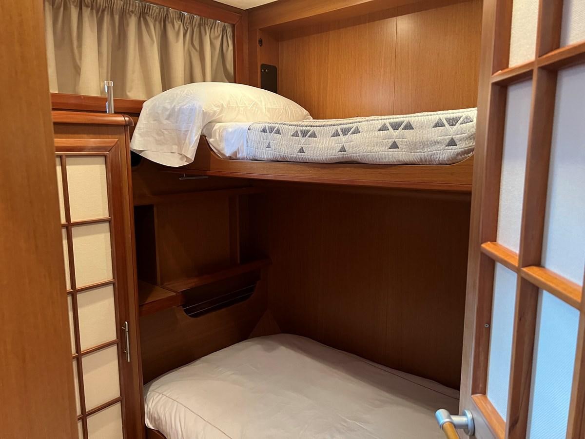 a bed with a white pillow aboard B Yacht for Sale