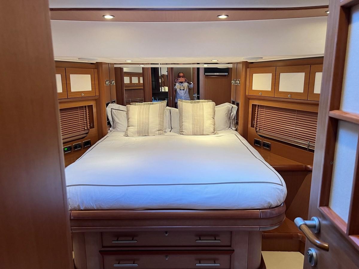 a person standing on a bed aboard B Yacht for Sale