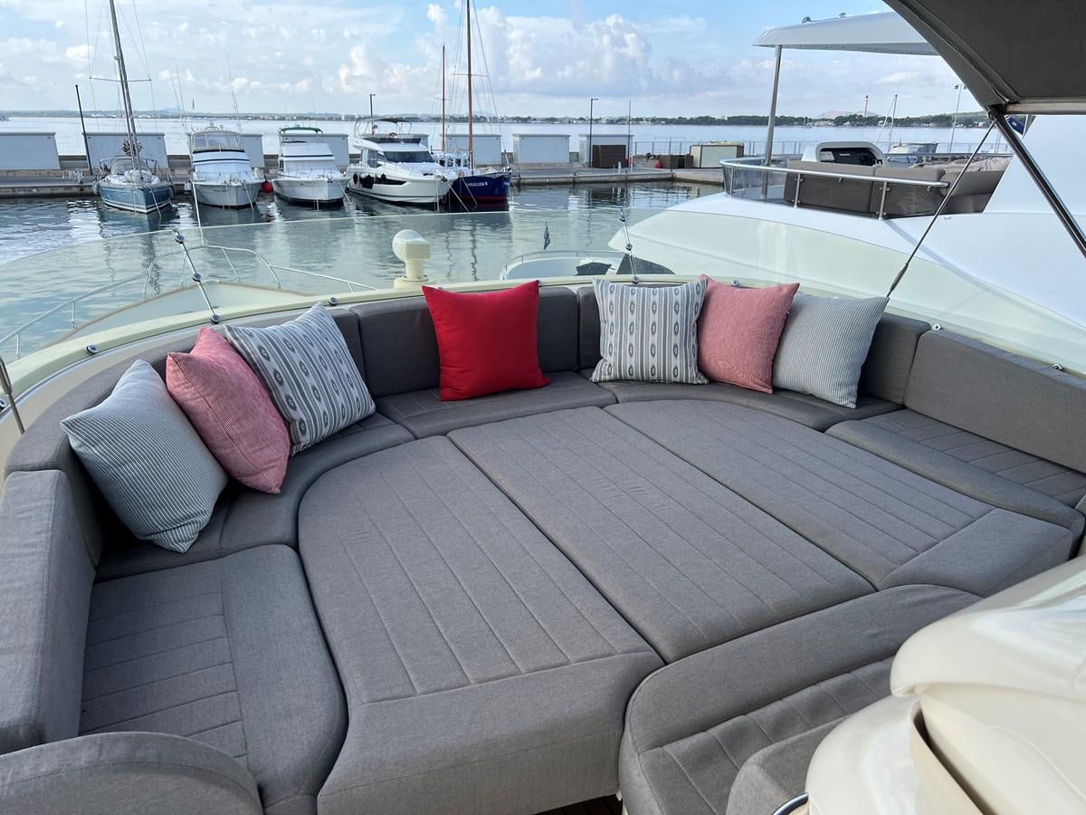a couch with pillows on it aboard B Yacht for Sale