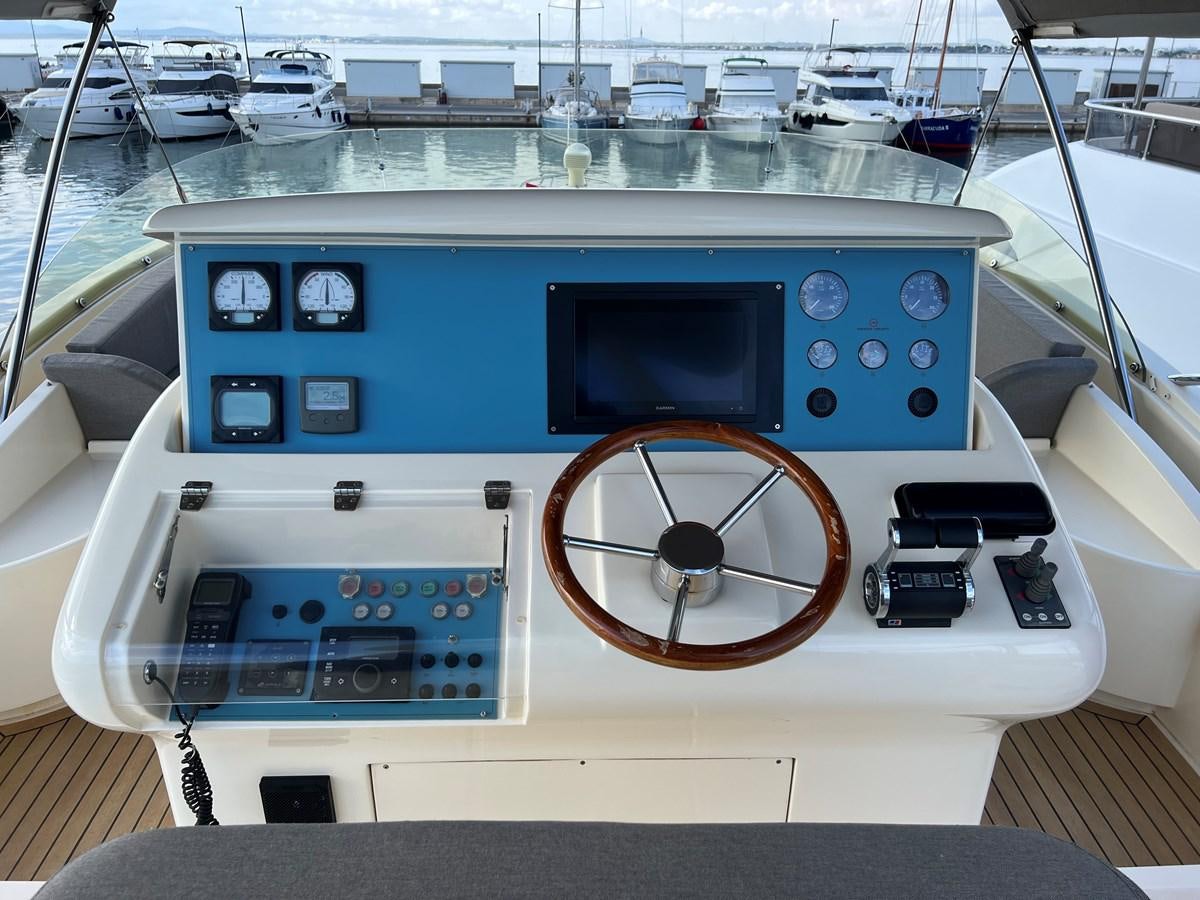 a boat with a steering wheel aboard B Yacht for Sale