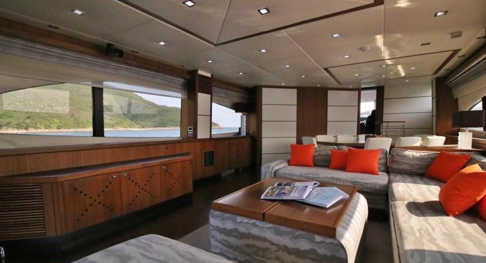 a living room with a couch and a table aboard AEGII Yacht for Sale