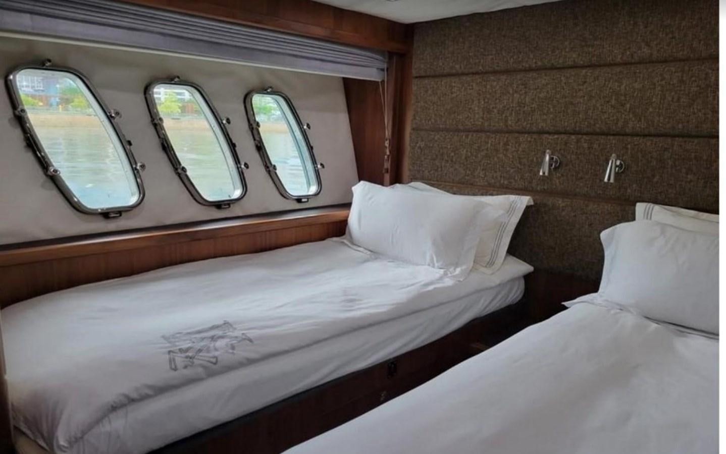a bed with a window aboard AEGII Yacht for Sale