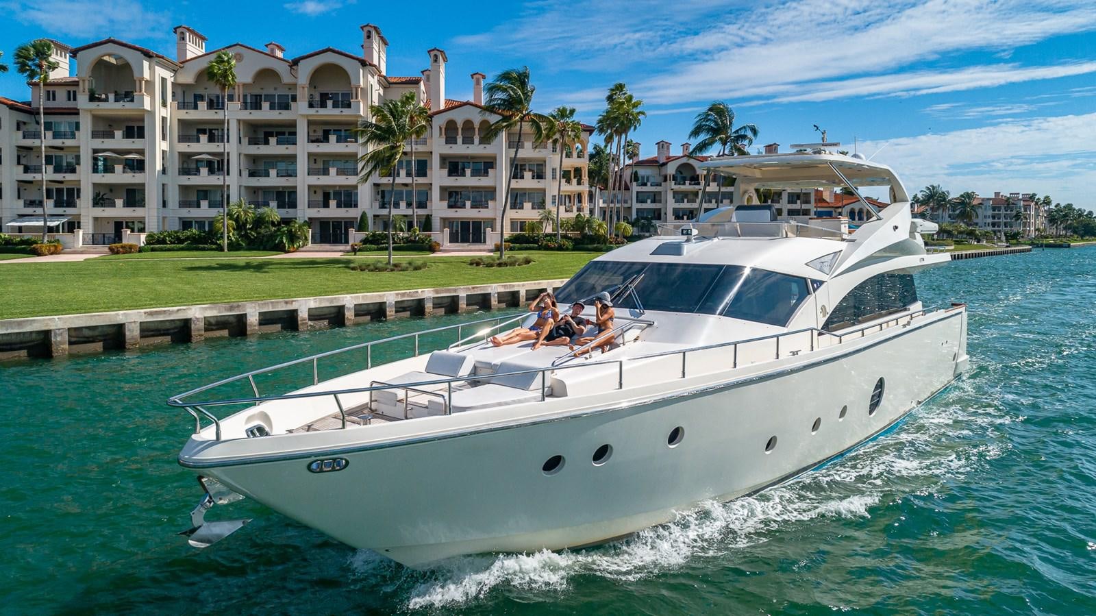 a white boat with people on it aboard THERAPY Yacht for Sale