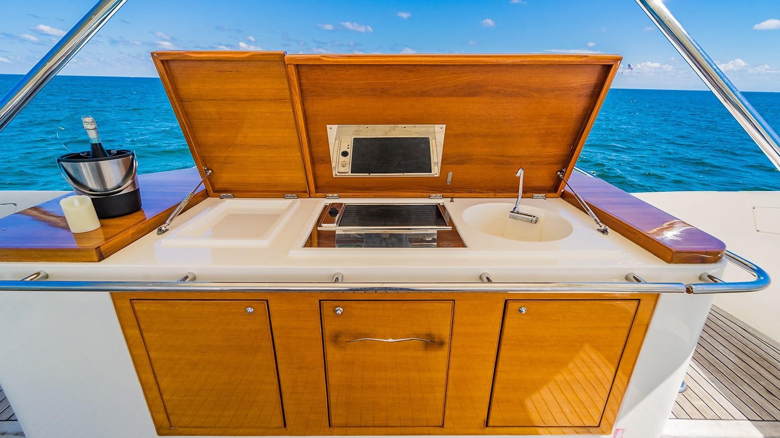 a boat with a sink and a wood cabinet on the side aboard THERAPY Yacht for Sale