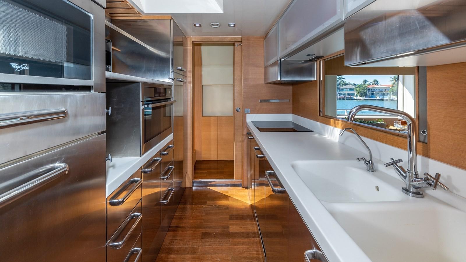 a kitchen with a sink and a large window aboard THERAPY Yacht for Sale