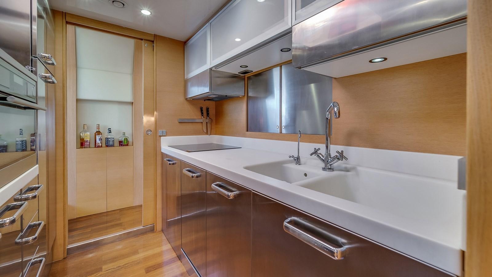 a kitchen with a sink and cabinets aboard THERAPY Yacht for Sale