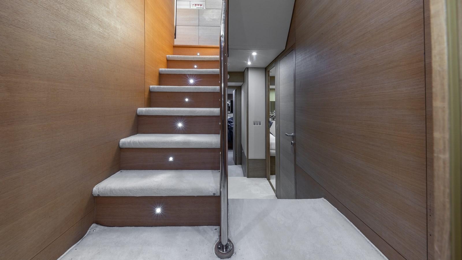 a wooden staircase in a room aboard THERAPY Yacht for Sale
