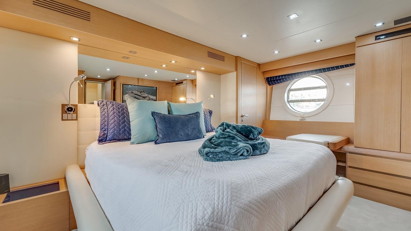 a room with a bed and a window aboard THERAPY Yacht for Sale