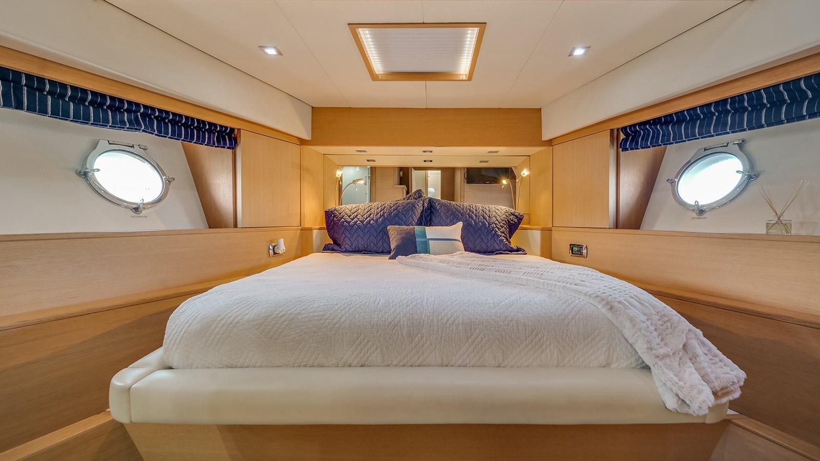 a room with a bed and a window aboard THERAPY Yacht for Sale