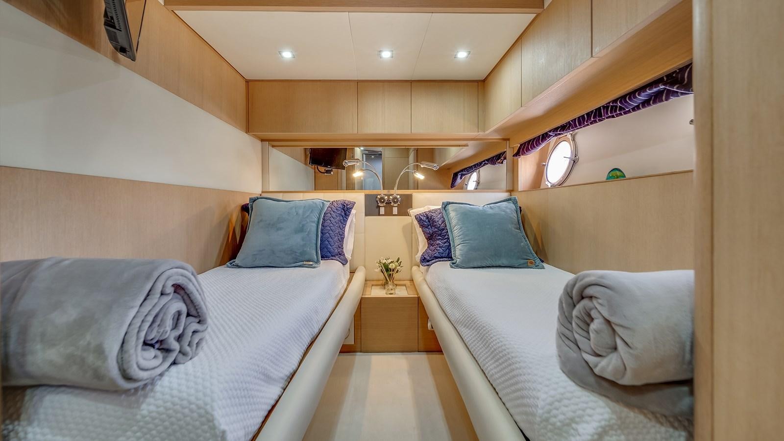a room with two beds aboard THERAPY Yacht for Sale