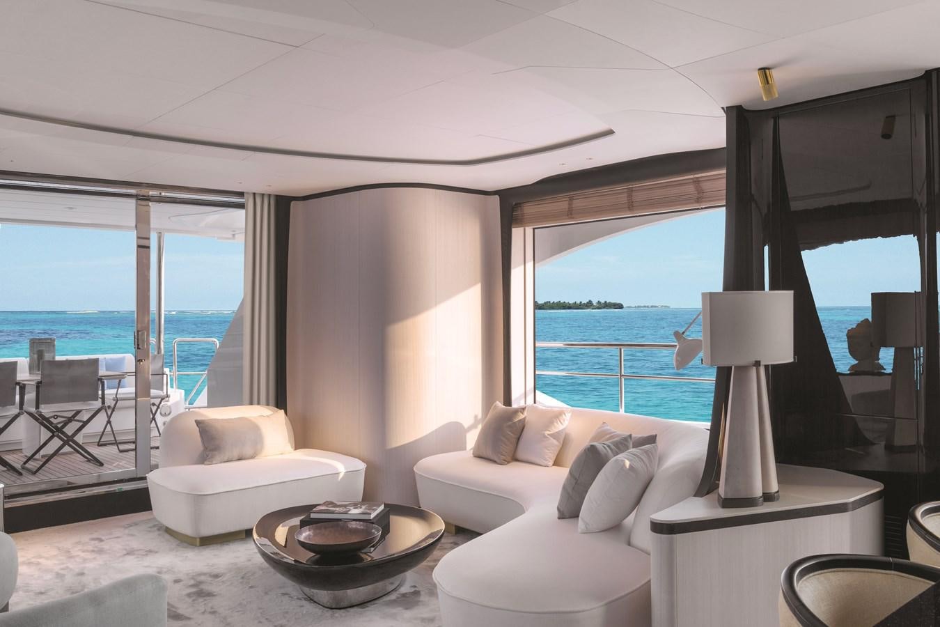 a room with a couch and a table and a lamp aboard SEANET CO_OWNERSHIP OFFER  Yacht for Sale