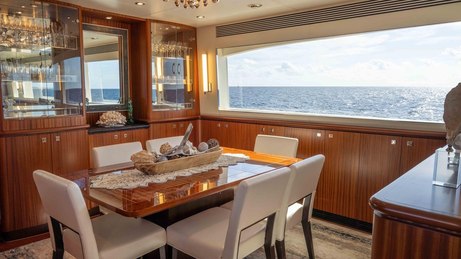 a kitchen with a table and chairs aboard SEA FAIRY Yacht for Sale