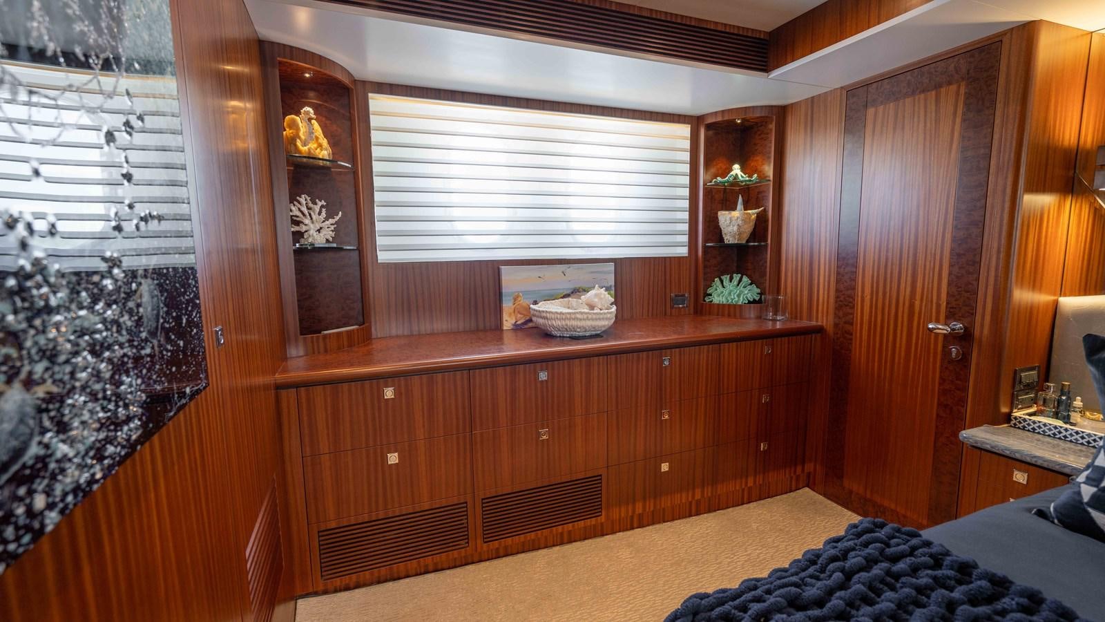 a room with a wood cabinet and a window aboard SEA FAIRY Yacht for Sale