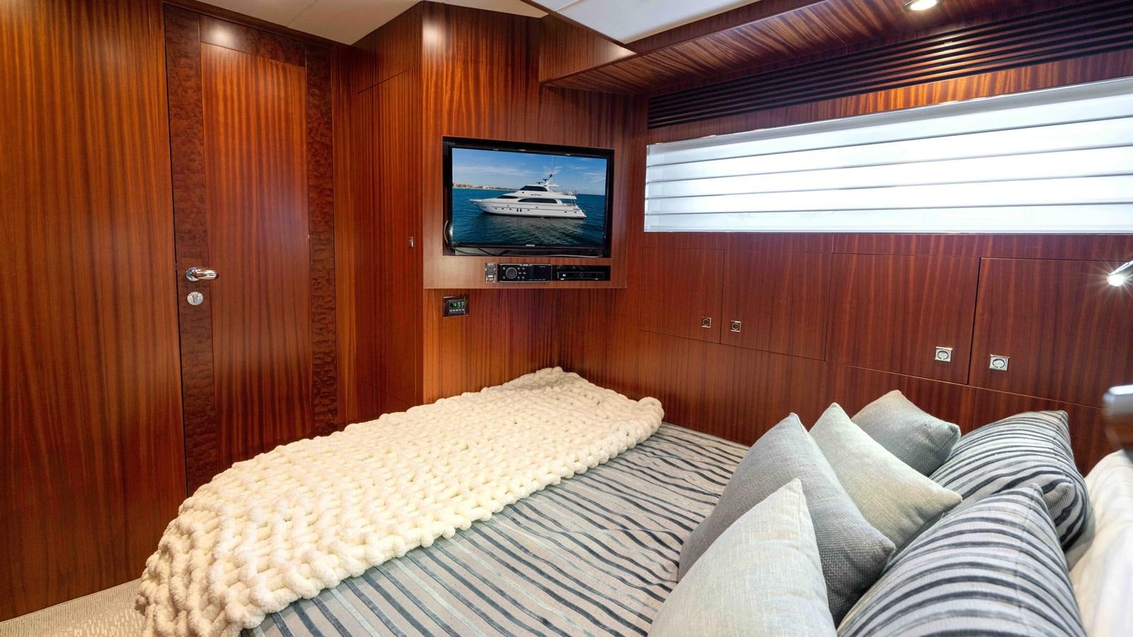 a bed with a television on the wall aboard SEA FAIRY Yacht for Sale