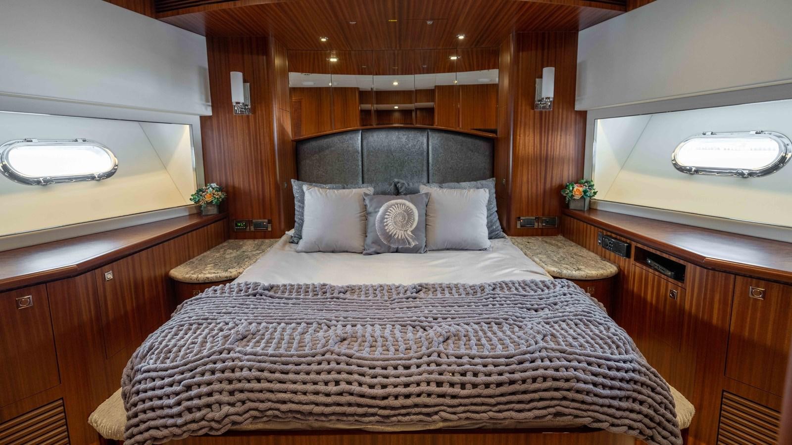 a bed with a white comforter aboard SEA FAIRY Yacht for Sale