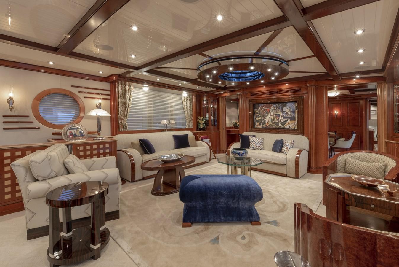 a living room with a large chandelier aboard NADAN Yacht for Sale
