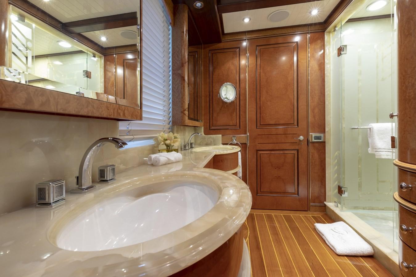 a bathroom with a sink and wooden cabinets aboard NADAN Yacht for Sale