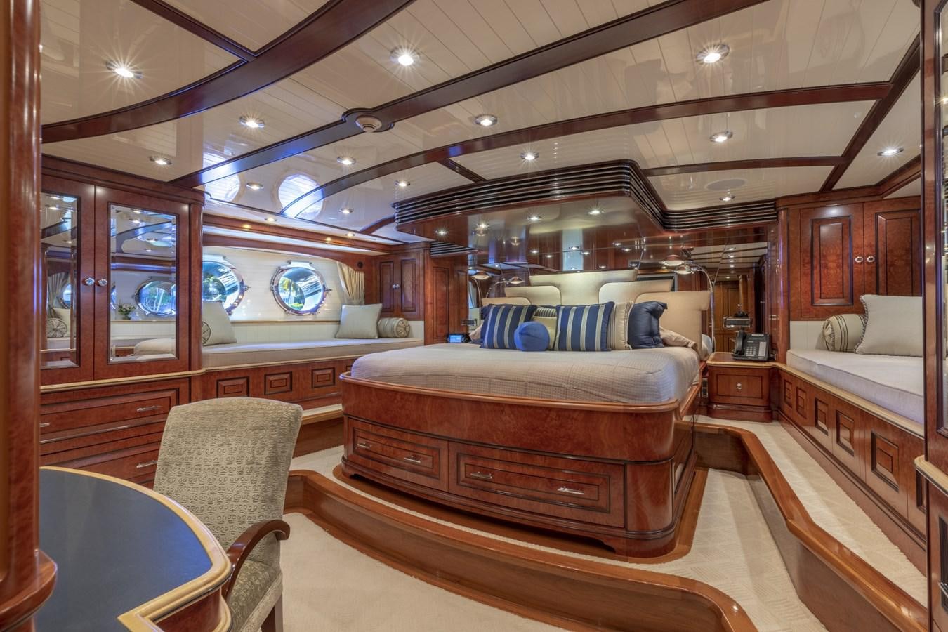 a room with a bed and a chair aboard NADAN Yacht for Sale