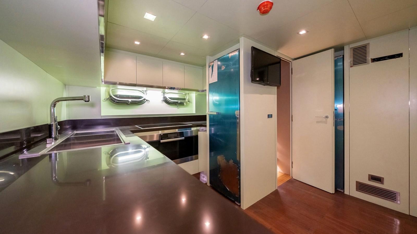 a kitchen with a large island aboard MAXI DRAGO Yacht for Sale