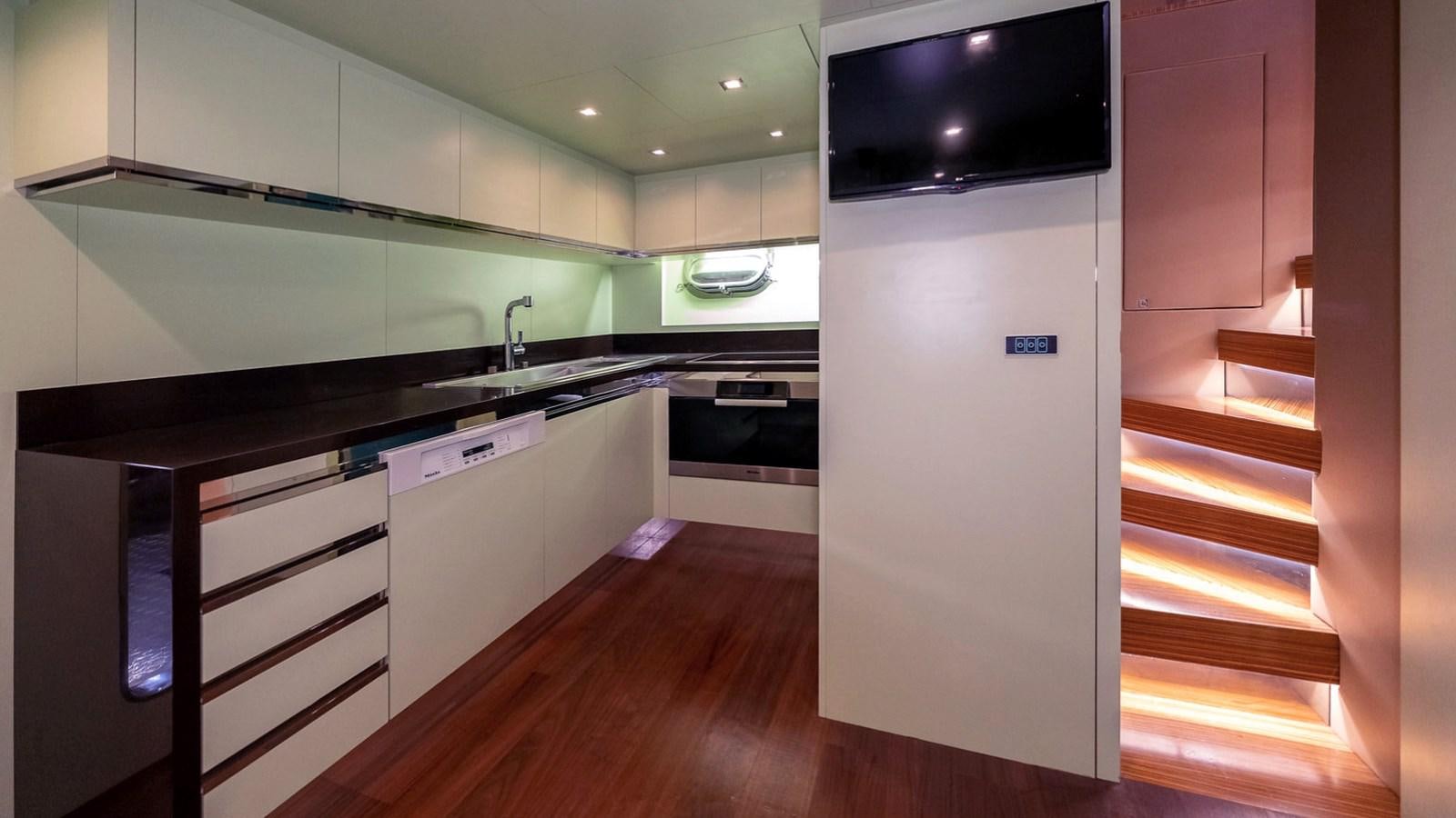 a kitchen with a wood floor aboard MAXI DRAGO Yacht for Sale