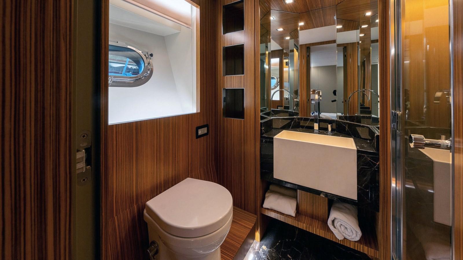 a bathroom with a sink toilet and a mirror aboard MAXI DRAGO Yacht for Sale
